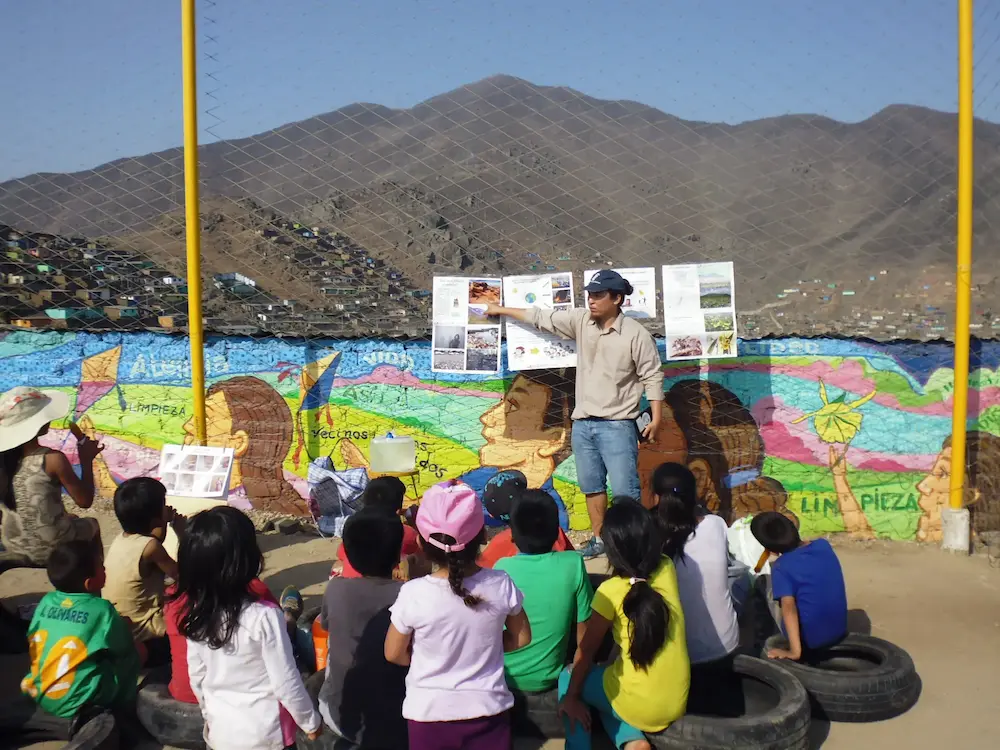Leading an environmental workshop in a Lima hillside community